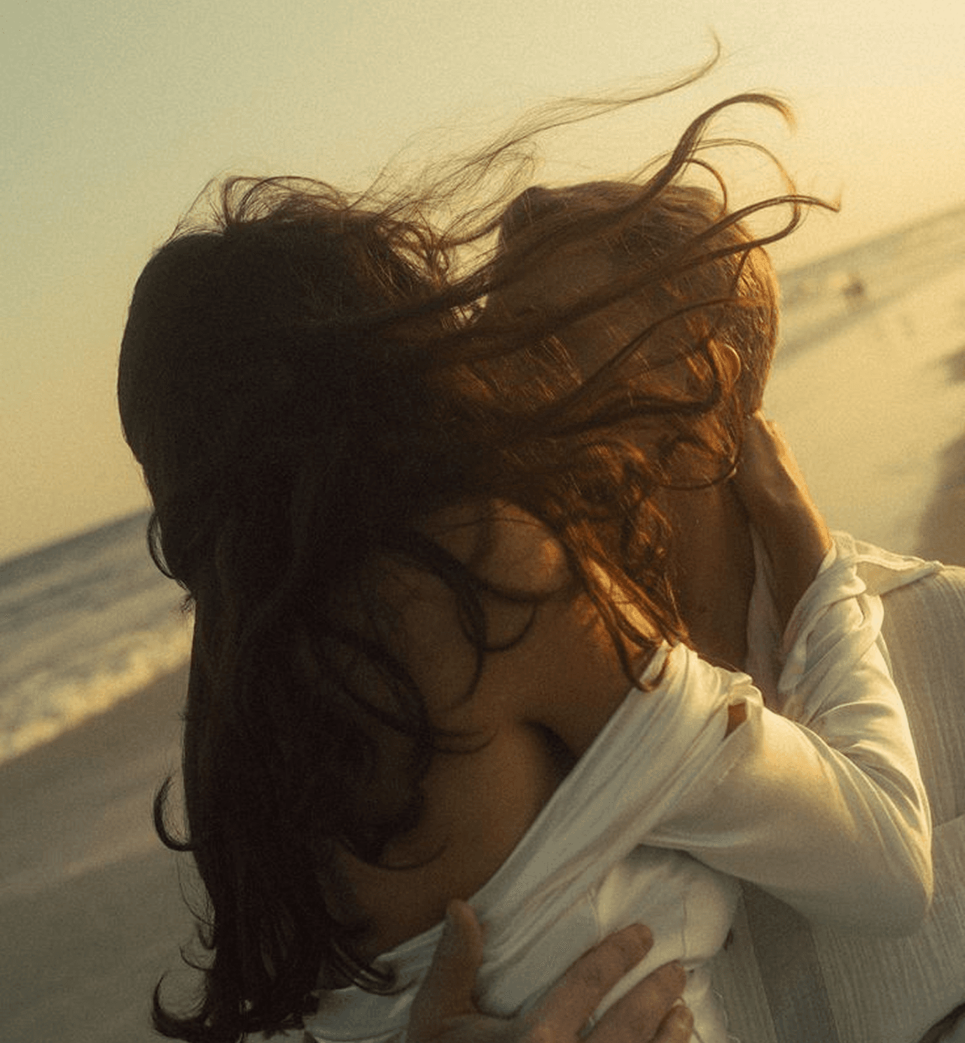 A woman with wind-swept hair at the coast