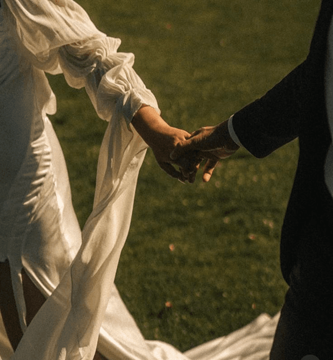 Two people holding hands at golden hour