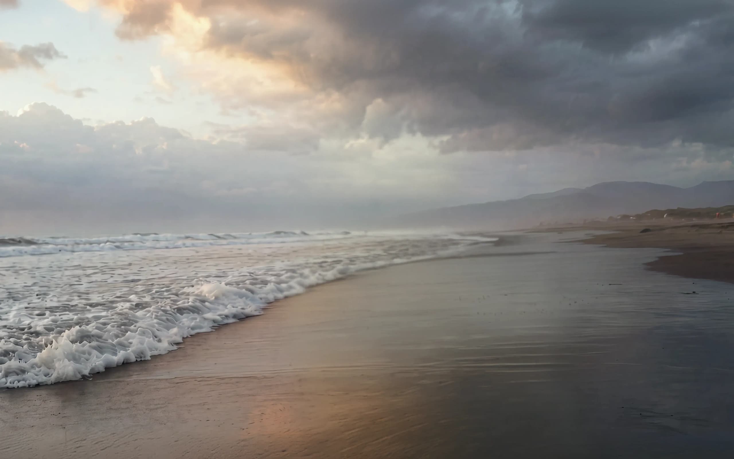 A woman looking out over the ocean at golden hour